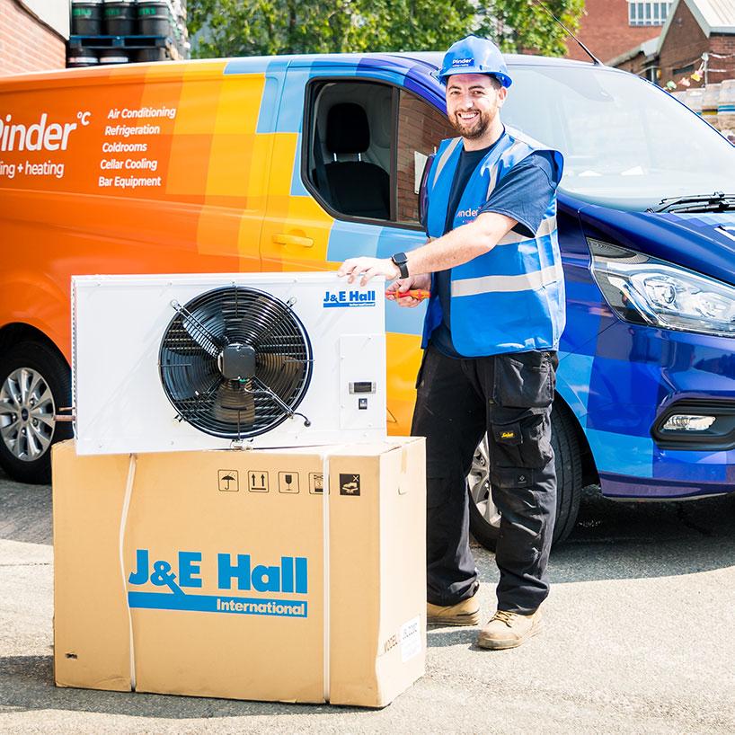 Pinder Cooling engineer posing with a J&E Hall Air Con unit